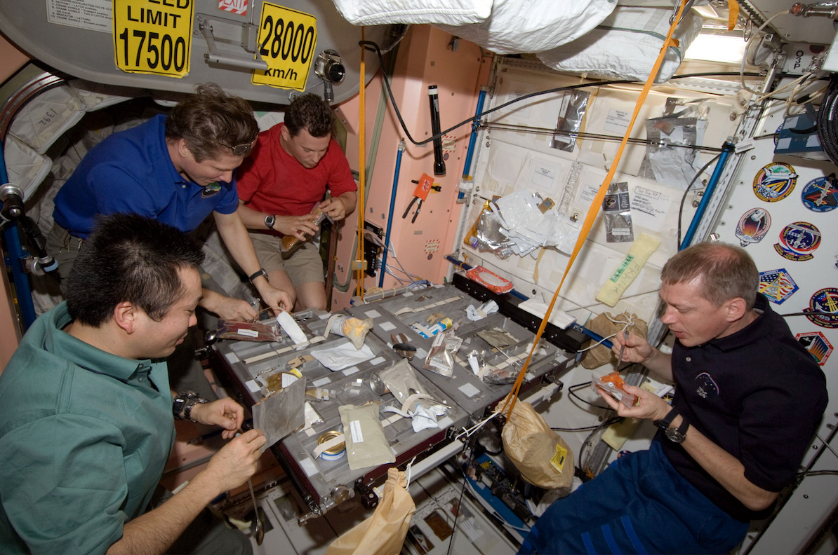 Expedition 20 crewmembers share a meal in the Unity module
